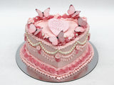 Heart-shaped Vintage Cake with Pink piped buttercream, Pearl Accents & Butterflies.