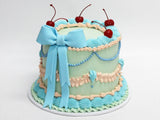 Blue Round Vintage Cake with piped buttercream and Blue Ribbon Bow