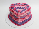 Heart-shaped Vintage Cake with pink and purple piped buttercream & Pearl Accents.